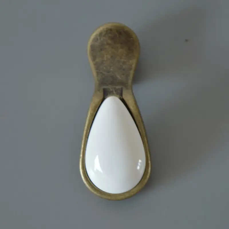 Azonnal elérhető Fém-porcelán bútorgomb, antik bronz (fém) és fehér (porcelán) színű, csepp formájú